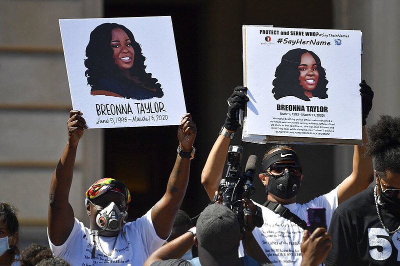 Signs are held up showing Breonna Taylor during a rally in her honor on the steps of the Kentucky state Capitol in Frankfort, Ky., on Thursday, June 25, 2020. The rally was held to demand justice in the death of Taylor, who was killed in her apartment by members of the Louisville Metro Police Department on March 13, 2020.