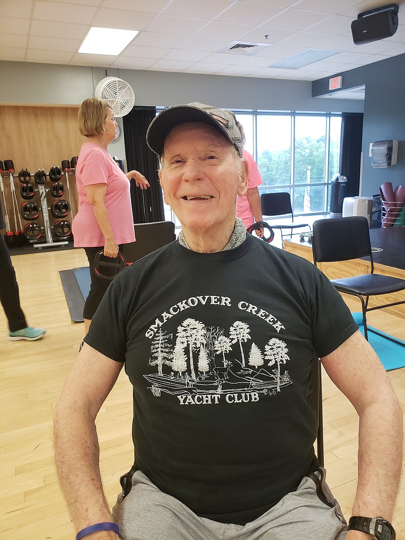 Smile: Dr. Laury Hamburg sits in the pose of contentment at HealthWorks Fitness Center. One piece of advice he gives regularly: Keep a smile on your face. (Provided)
