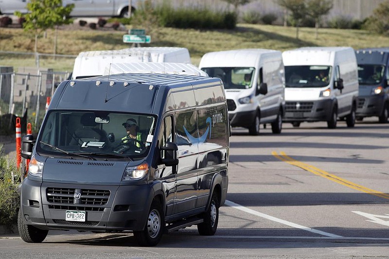 Amazon vans line up to leave a delivery center in suburban Englewood, Colo., in this file photo. Amazon said Friday that it merging into the self-driving vehicle technology in a deal with the Zoox company.
(AP)