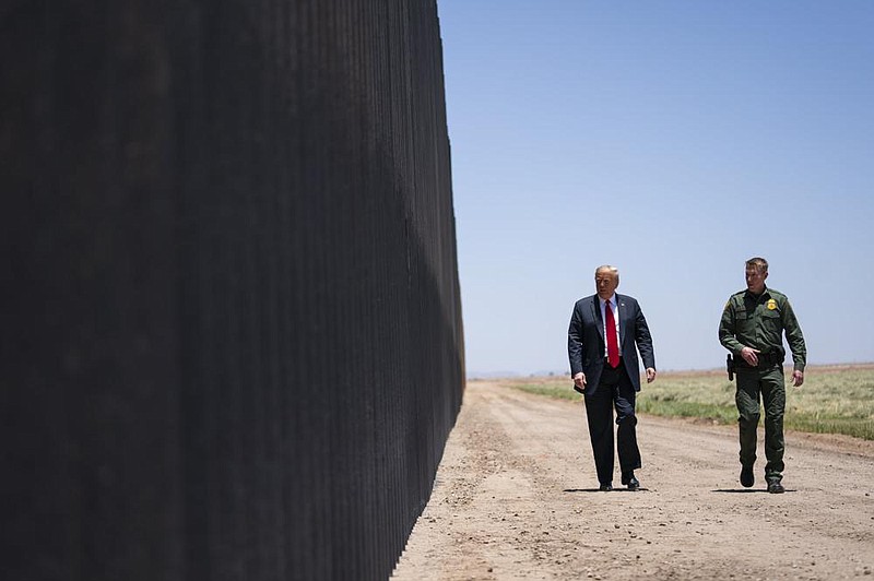 U.S. Border Patrol chief Rodney Scott gives President Donald Trump a tour of a section of the border wall Tuesday in San Luis, Ariz.
(AP/Evan Vucci)