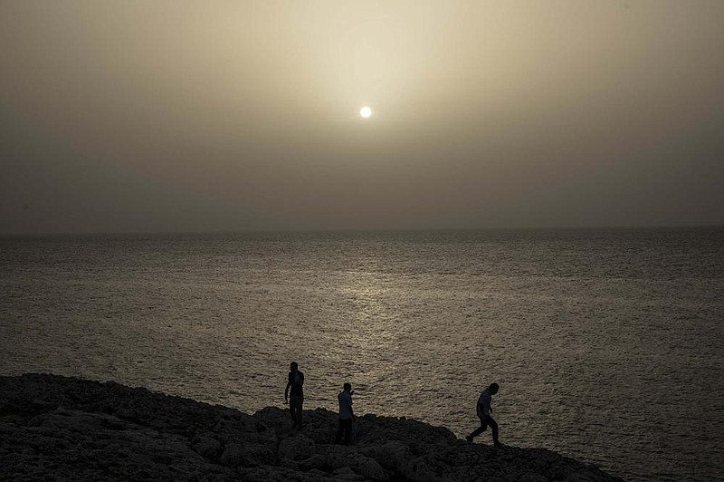 People watch the sunset Wednesday in Havana while a cloud of Sahara dust hangs in the air. The dust cloud is affecting air quality in much of the southern United States.
(AP/Ramon Espinosa)