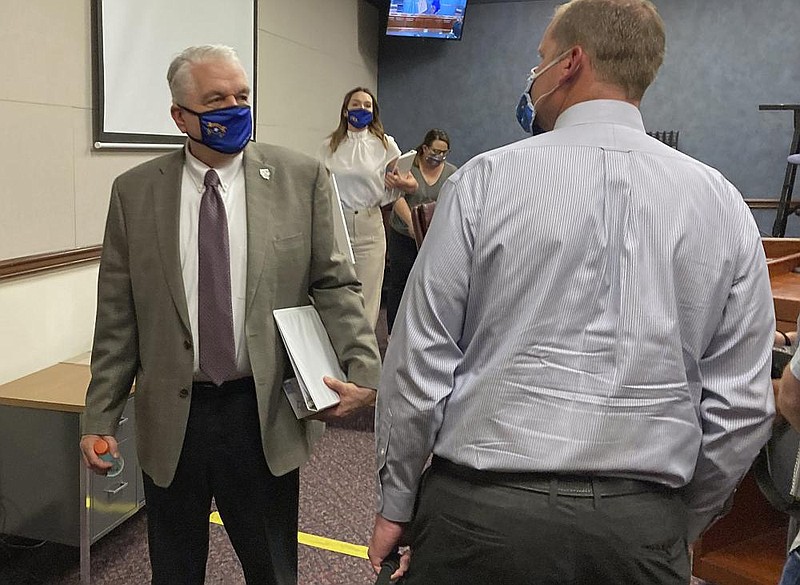 Nevada Gov. Steve Sisolak (left) leaves a news conference in Carson City last week after announcing that Nevada would join California, Washington and North Carolina in requiring people to wear masks in public places. More photos at arkansasonline.com/628governors/
(AP/Samuel Metz)