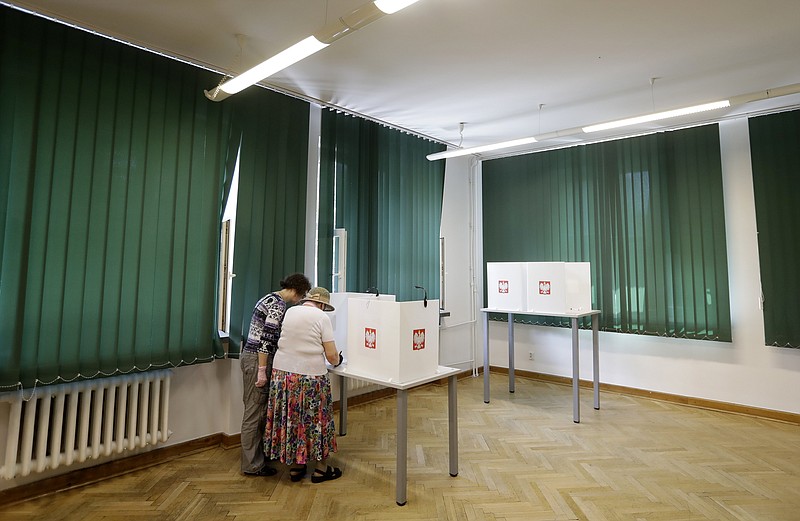People in Warsaw, Poland, prepare to cast their votes in Sunday’s presidential election. More photos at arkansasonline.com/629poland/.
(AP/Petr David Josek) story.lead_photo.caption