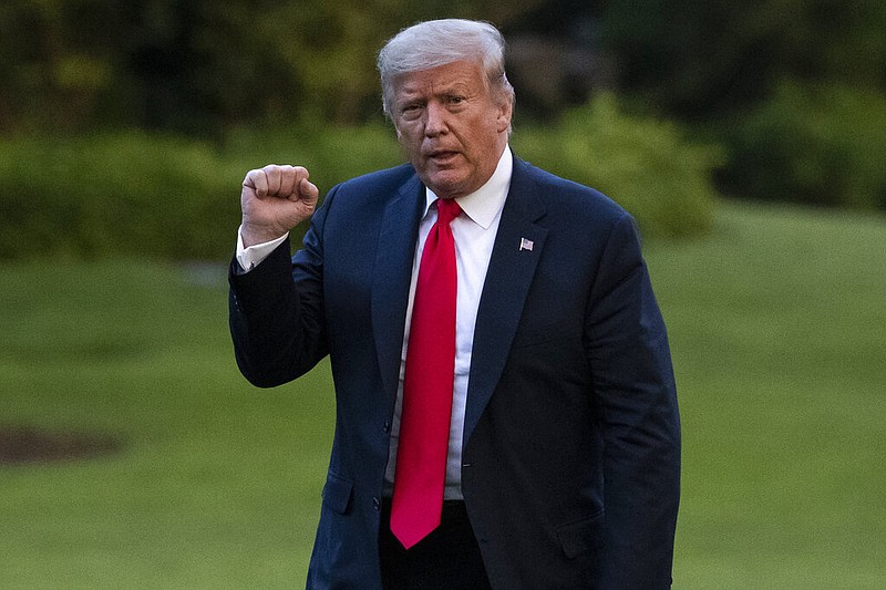 President Donald Trump pumps his fist as he walks on the South Lawn after arriving on Marine One at the White House, Thursday, June 25, 2020, in Washington. Trump is returning from Wisconsin. (AP Photo/Alex Brandon)


