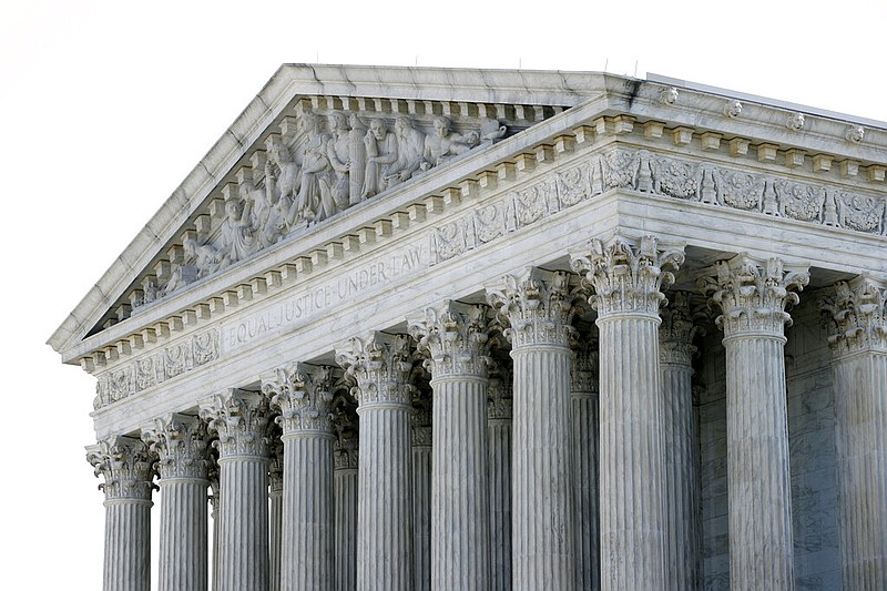 The sun rises behind the Supreme Court on Capitol Hill in Washington, Monday, June 29, 2020.
