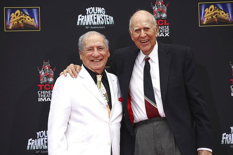 FILE - In this Sept. 8, 2014 file photo, Mel Brooks, left, stands with Carl Reiner during Brooks' hand and footprint ceremony on the 40th anniversary of the movie "Young Frankenstein," in Los Angeles. Reiner, the ingenious and versatile writer, actor and director who broke through as a “second banana” to Sid Caesar and rose to comedy’s front ranks as creator of “The Dick Van Dyke Show” and straight man to Mel Brooks’ “2000 Year Old Man,” has died, according to reports. Variety reported he died of natural causes on Monday night, June 29, 2020, at his home in Beverly Hills, Calif. He was 98. (AP Photo/Nick Ut, File)