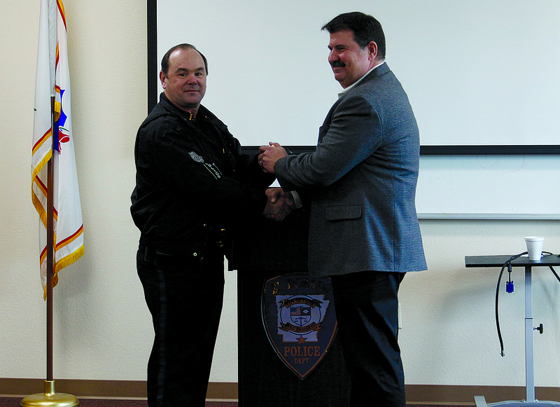 El Dorado Police Chief Kenny Hickman, right, shakes hands with his predecessor Billy White. (News-Times file)