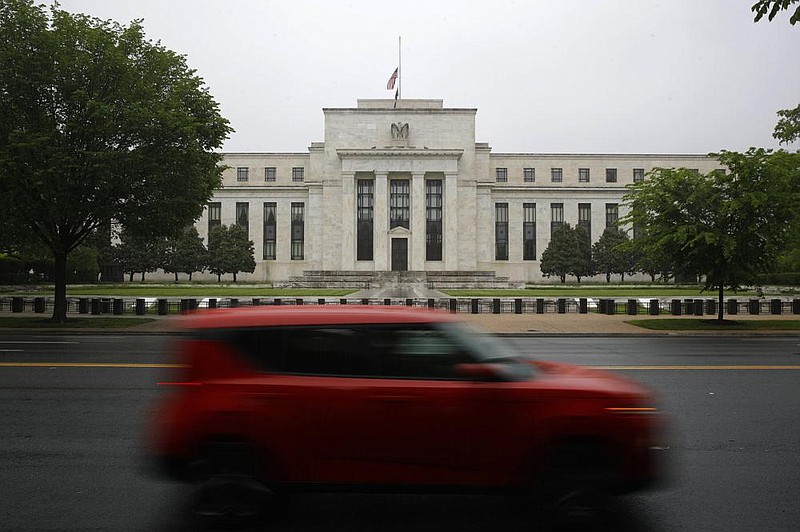 File-In this May 22, 2020, file photo, a car drives past the Federal Reserve building in Washington. The Federal Reserve on Sunday, June 28, 2020, released a list of roughly 750 companies, including Apple, Walmart, and ExxonMobil, whose corporate bonds it will purchase in the coming months in an effort to keep borrowing costs low and smooth the flow of credit. The central bank also said it has, so far, purchased nearly $429 million in corporate bonds from 86 of those companies, including AT&amp;T, Walgreen's, Microsoft, Pfizer, and Marathon Petroleum.