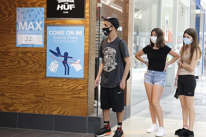 Customers wait in line Monday to enter a store at Garden State Plaza in Paramus, N.J. The state’s Monday after their covid-19 closure. (AP/Seth Wenig) 