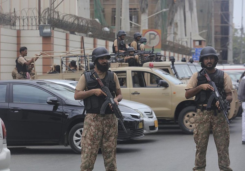 Security personnel surround the Stock Exchange Building in Ka- rachi, Pakistan, after a Monday attack. More photos available at arkansasonline.com/630pakistan/
(AP/Fareed Khan)
story.lead_photo.caption