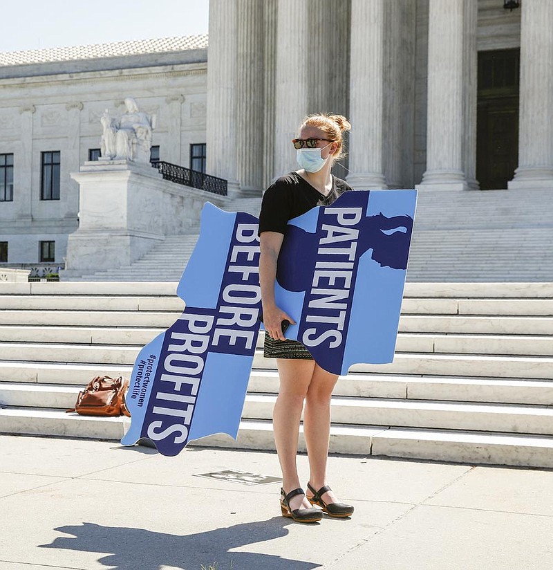 An anti-abortion protester stands Monday outside the Supreme Court in Washington. More photos at arkansasonline.com/630court/. (AP/Patrick Semansky) 