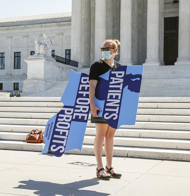 An anti-abortion protester stands Monday outside the Supreme Court in Washington. More photos at arkansasonline.com/630court/.
(AP/Patrick Semansky) story.lead_photo.caption