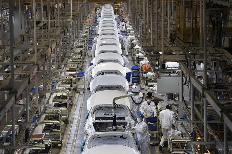 Employees work on a car assembly line in April at the Dongfeng Honda Automobile factory in Wuhan, China. (AP/Ng Han Guan) 