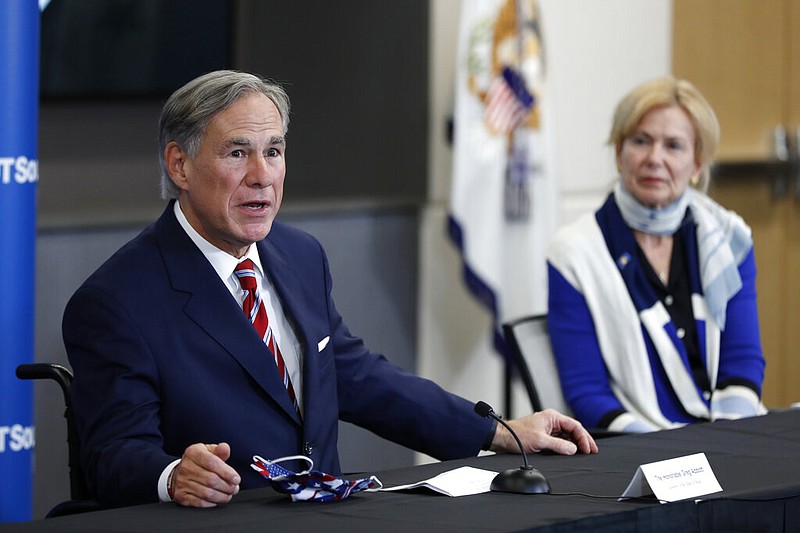 Texas Gov. Greg Abbott responds to a question as Dr. Deborah Birx, White House coronavirus response coordinator, looks on during a news conference on covid-19 at the University of Texas Southwestern Medical Center West Campus in Dallas on Sunday, June 28, 2020.