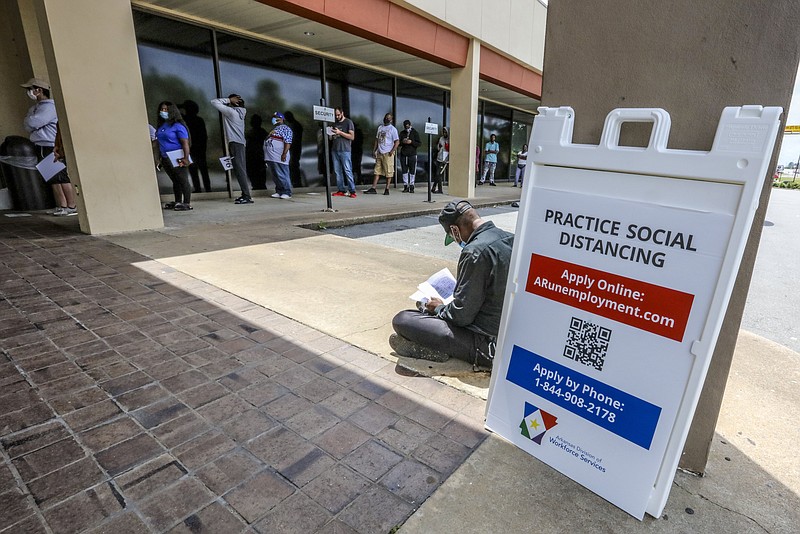 FILE -- A man fills out paperwork outside the Arkansas Workforce Center, at 5401 South University Avenue in Little Rock, Wednesday morning, May 13, 2020. (Arkansas Democrat-Gazette/John Sykes Jr.)