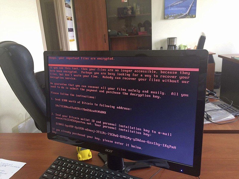 A computer screen cyberattack warning notice reportedly holding computer files to ransom, as part of a massive international cyberattack, at an office in Kiev, Ukraine, Tuesday June 27, 2017. The El Dorado Police Department was recently hit with a similar virus. (Oleg Reshetnyak via AP)