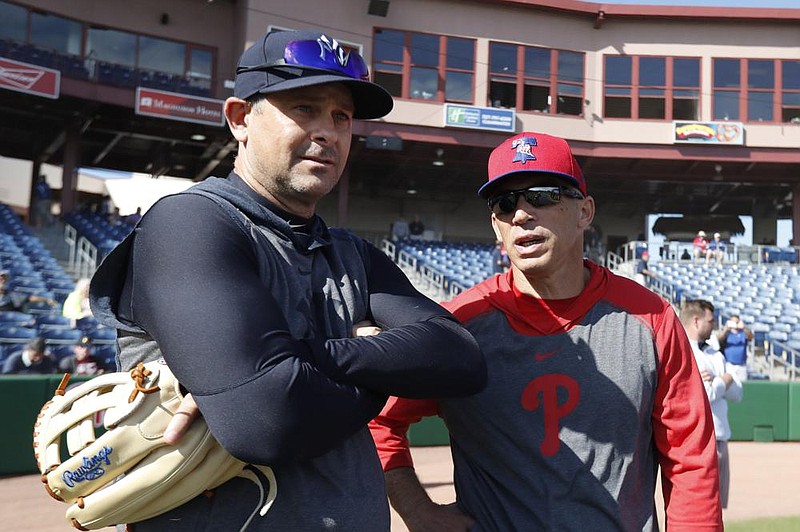 New York Yankees Manager Aaron Boone (left), shown with Philadelphia Phillies Manager Joe Girardi in March, will address his team Saturday for the first time since training camp opened, but will do so in waves because of coronavirus protocols.
(AP/Carlos Osorio)
