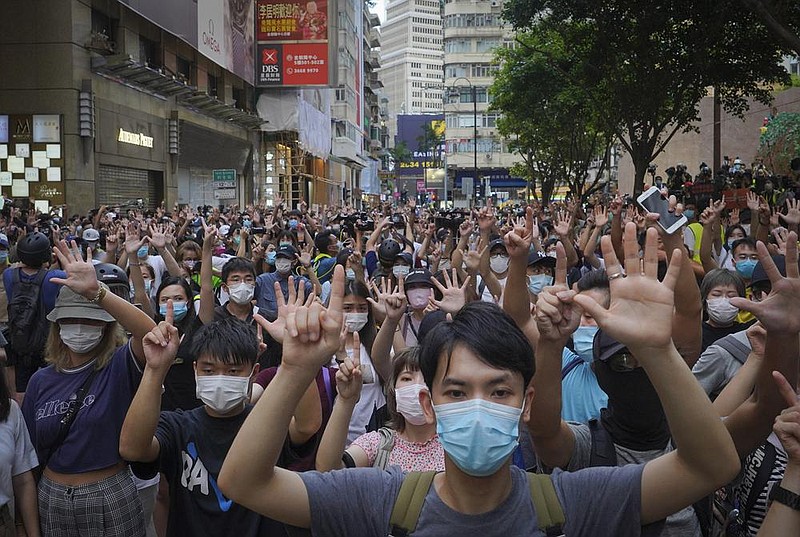 In Hong Kong on Wednesday, protesters against the new national security law gesture with five fingers, signifying “five demands — not one less” on the anniversary of Hong Kong’s handover to China from Britain. More photos are available at arkansasonline.com/72hongkong/
(AP/Vincent Yu)