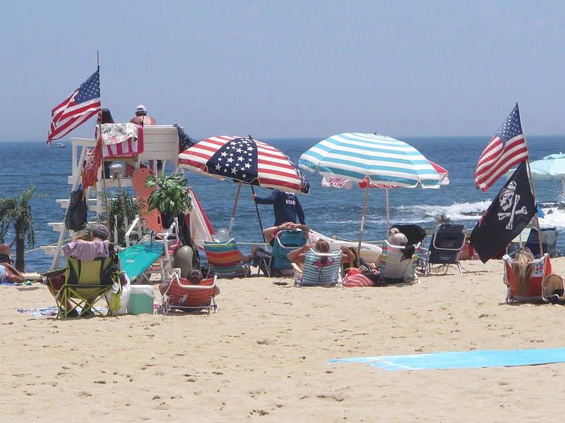 Flags line the beach in Belmar, N.J., on June 28, 2020. With large crowds expected at the Jersey Shore for the July Fourth weekend, some are worried that a failure to heed mask-wearing and social distancing protocols could accelerate the spread of the coronavirus. 

