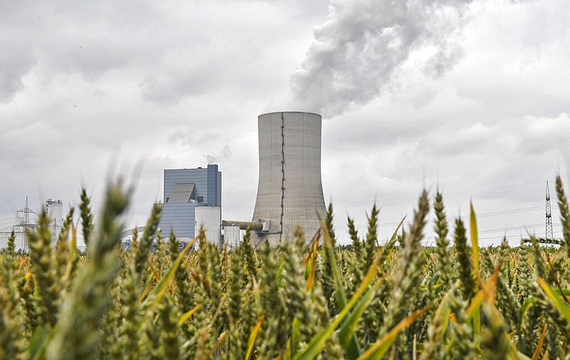 The controversial most modern Uniper Datteln 4 coal-powered plant steams behind a corn field one month after the operational start in Datteln, Germany, Friday, July 3, 2020. The state governors Dietmar Woidke of Brandenburg, Michael Kretschmer of Saxony, Reiner Haseloff of Saxony-Anhalt and Armin Laschet of North Rhine-Westphalia meet in Berlin for the adoption by the Bundestag and Bundesrat of the laws on coal phase-out and structural strengthening in the affected federal states. (AP Photo/Martin Meissner)