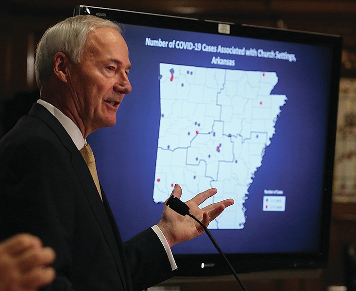 Gov. Asa Hutchinson, speaking at the state Capitol in Little Rock, shows a breakdown of covid-19 cases associated with church settings in this Friday, June 26, 2020, file photo. Arkansas Baptist State Convention executive director J.D. “Sonny” Tucker wrote in a June 28 email to top state officials that the governor and Health Secretary Dr. Nate Smith created a false impression during that day's briefing that the churches had disregarded state health directives.