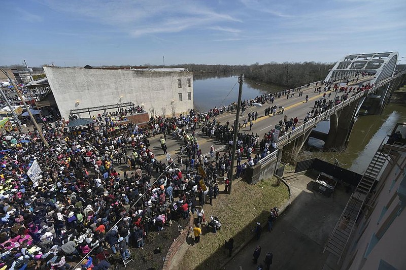 A crowd gathers before a symbolic walk across the Edmund Pettus Bridge in Selma, Ala., in this 2015 file photo. The bridge was named after a Confederate general and reputed KKK grand wizard who was in the U.S. Senate at a time when Jim Crow laws gave white people near-total control in Alabama.
(AP/Mike Stewart)