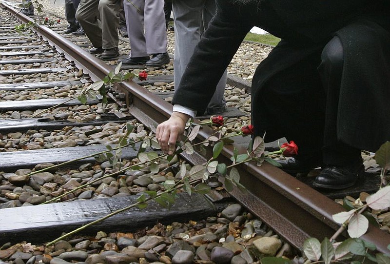 In this file photo from May 9, 2015, roses are symbolically placed on the railroad tracks at former concentration camp Westerbork, the Netherlands, remembering more than a hundred thousand Jews transported from Westerbork to Nazi death camps during WWII. The NS railway company announced that it will donate $5.6 million to Dutch Holocaust memorial centers as a gesture of collective recognition, but Jewish organizations criticized the company Monday for not adequately consulting them in discussions.
(AP/Peter Dejong)