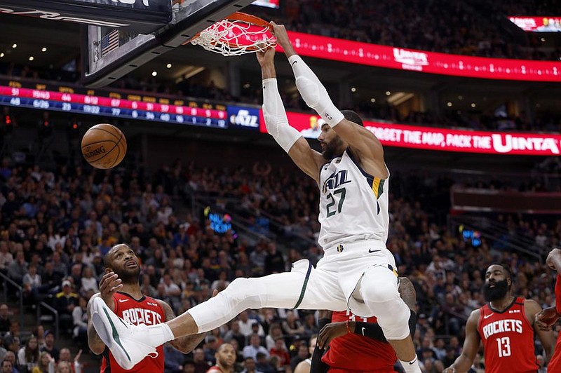 Utah’s Rudy Gobert dunks during the second half against the Hous- ton Rockets on Feb. 22 in Salt Lake City. Gobert was the rst NBA player to test positive for covid-19, which prompted many to blame him for the league’s shutdown. 
(AP/Kim Raff) 