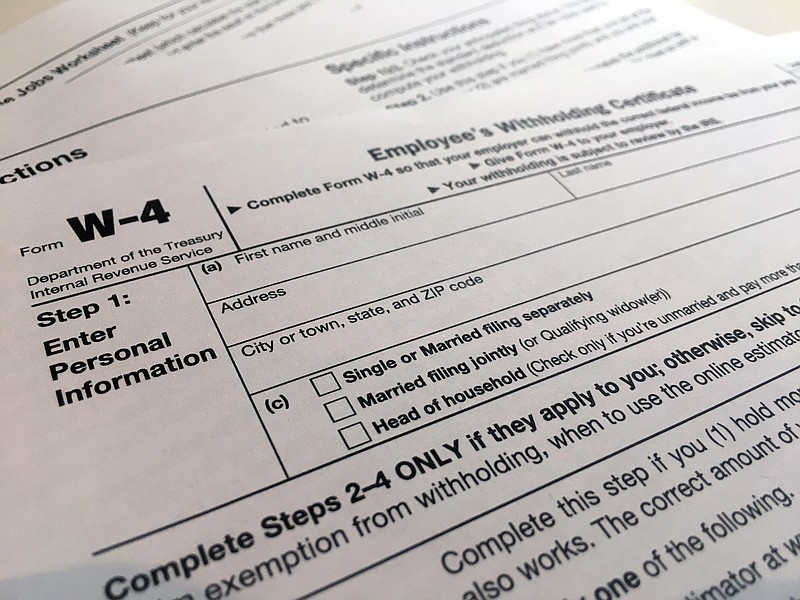 FILE - In this Feb. 5, 2020, file photo, a W-4 form is viewed in New York. As the coronavirus pandemic took hold this spring, the federal government postponed the traditional April 15 filing deadline until July 15. The move provided some economic and logistic relief for taxpayers dealing with the disruptions and uncertainty brought on by lockdowns, school closures and shuttered businesses. But now that new deadline is rapidly approaching. (AP Photo/Patrick Sison, File)