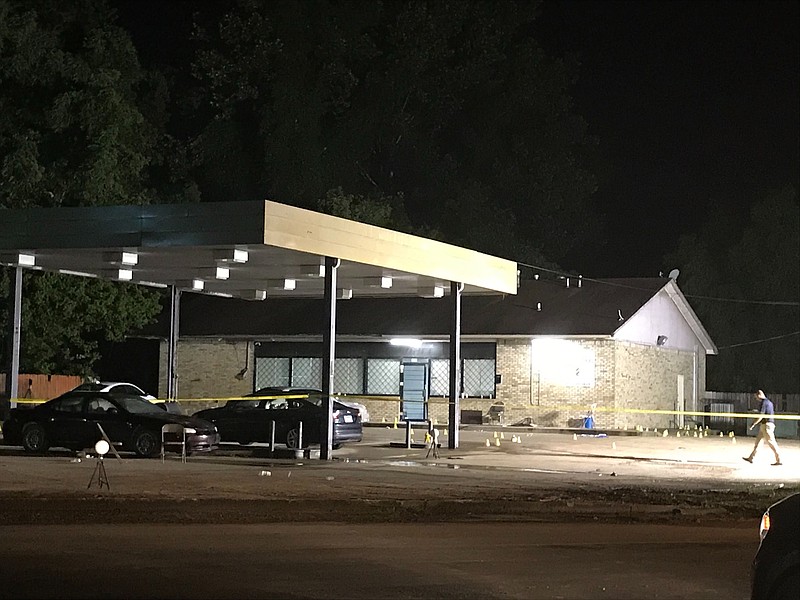 An investigator works at the scene of a Sunday night shooting in Helena-West Helena that killed one person and injured three others, according to police.