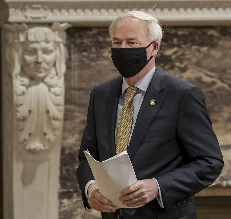 Governor Asa Hutchinson enters the Governor’s Conference Room on Monday, July 6 to discuss the state’s response to the ongoing COVID-19 pandemic. The event was held at the state capitol in downtown Little Rock. (Arkansas Democrat-Gazette/John Sykes Jr.)