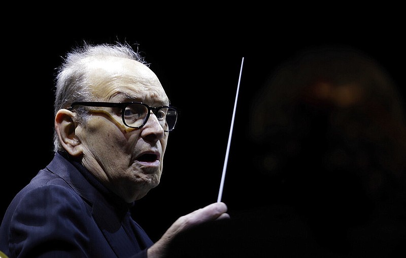 FILE - In this file photo dated Tuesday, March 6, 2018, Italian composer Ennio Morricone directs an ensemble during a concert of his "60 Year Of Music World Tour", in Milan, Italy.