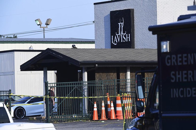 Police tape blocks off the scene of Sunday’s fatal shooting at the Lavish Lounge in Greenville, S.C. Video at arkansasonline. com/76scshooting/. (AP/The Greenville News/Ken Ruinard) 