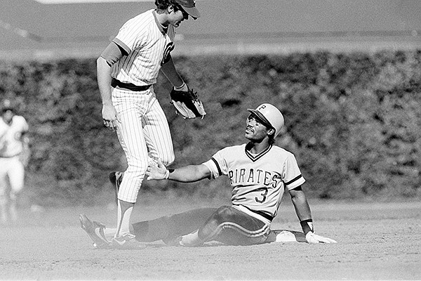 Johnny Ray gestures toward Chicago Cubs' second baseman Ryne Sandberg during eighth inning action in Chicago, June 25, 1984. Ray was out at second on a double play that took Pirates' Bill Madlock out at first. The Pirates won the contest, 3-0. (AP Photo/John Swart)