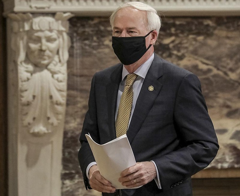 Gov. Asa Hutchinson arrives Monday afternoon for the coronavirus briefing at the state Capitol in Little Rock. More photos at arkansa- sonline.com/77govbrief/.
(Arkansas Democrat-Gazette/John Sykes Jr.)
story.lead_photo.caption
