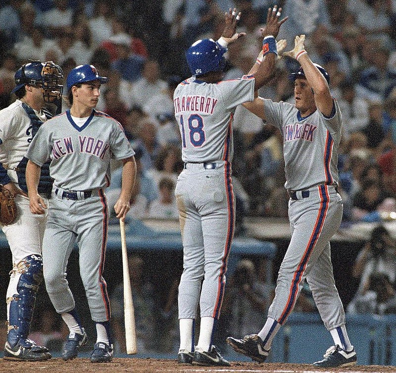 Former New York Mets left fielder Kevin McReynolds (right) is congratulated by teammate Darryl Strawberry after hitting a two-run home run in a 1988 game. McReynolds, a North Little Rock native who won the Southwest Conference’s first triple crown at Arkan- sas in 1980, played 11 seasons in the major leagues and was known for his versatility. (AP file photo) 
