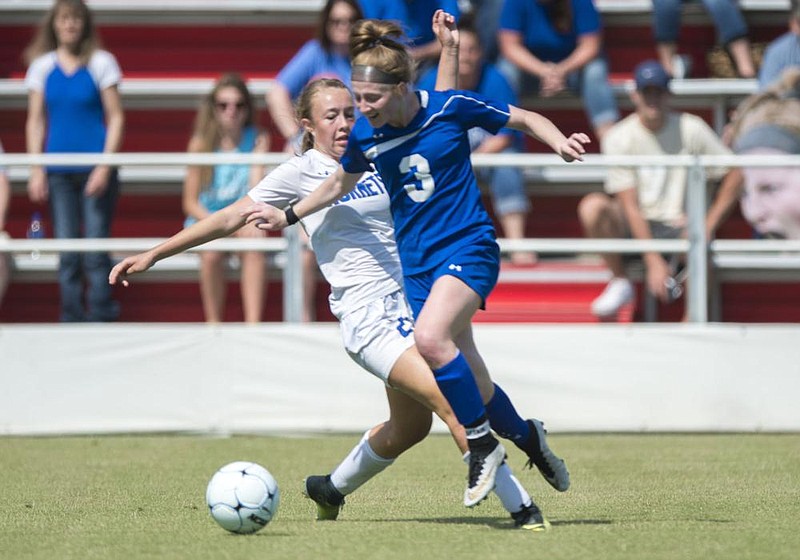 NWA Democrat-Gazette/CHARLIE KAIJO Rogers High School midfielder Skylurr Patrick (3) and Bryant High School Abbey Inman (21) fight for possession of the ball during the 7A State Girls Soccer Championship, Friday, May 18, 2018 at Razorback Field in Fayetteville. Rogers defeated Bryant High School with a score by midfielder Skylurr Patrick (3) in overtime to break a 2-2 tie. Patrick scored all three of the team's goals during the championship game.

