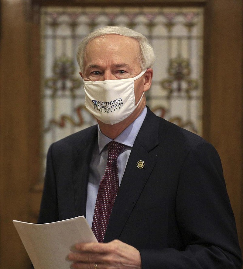 Gov. Asa Hutchinson arrives Wednesday July 8 at the state Capitol in Little Rock for his daily COVID-19 briefing. (Arkansas Democrat-Gazette/Staton Breidenthal)