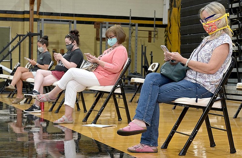 Donors check their phones as they wait their turn during a blood drive at the Boone Fitzpatrick Fieldhouse at Little Rock Central High School on Tuesday, July 7, 2020. The blood drive also offered donors a free COVID-19 antibody test in the effort to get 100 units of blood donated for the day.


(Arkansas Democrat-Gazette / Stephen Swofford)
