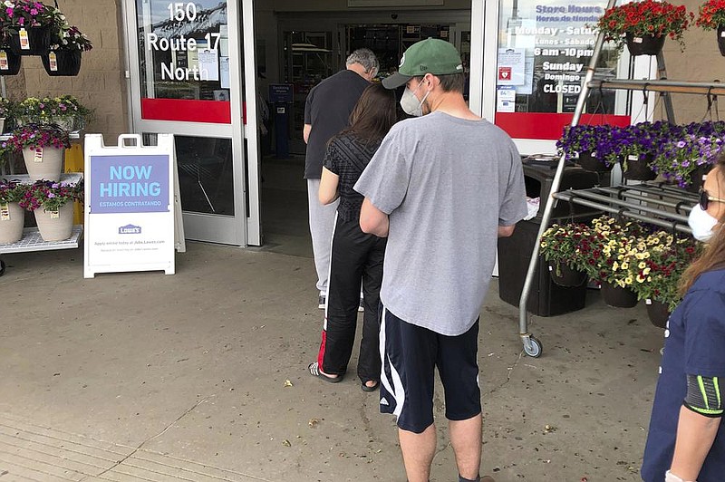 A hiring sign is posted in front of a Lowe’s Home Improvement store in East Rutherford, N.J., in May. The number of available jobs rose in May to 5.4 million from 5 million in April, the Labor Department said Tuesday. (AP) 