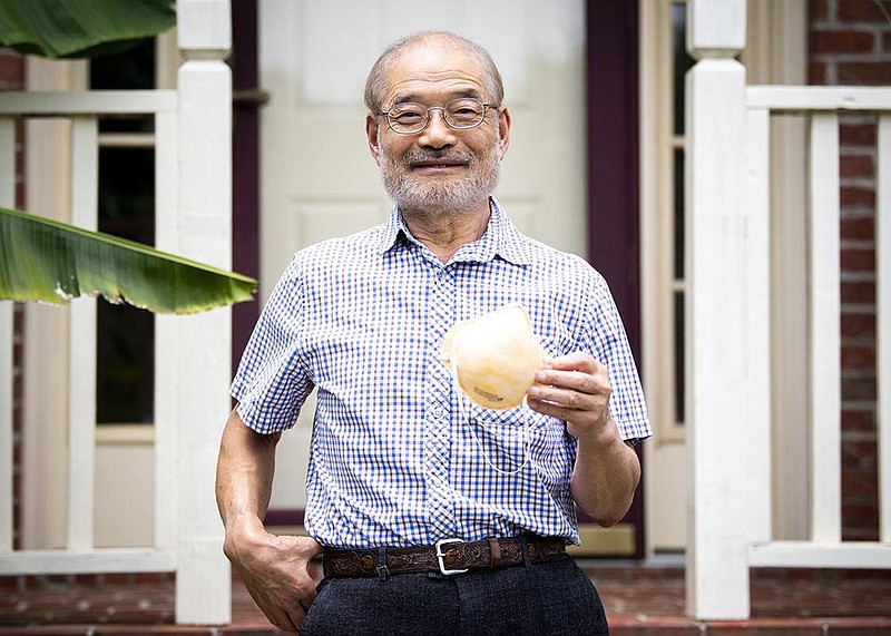 This June 3, 2020 photo shows Peter Tsai, the inventor of the N95 filtration material, at his Knoxville, Tenn., home.  Since mid-March, Tsai has been a worldwide force on two fronts — finding new ways to sterilize disposable respirators for reuse and rapidly scaling up their production.  (Brianna Paciorka/Knoxville News Sentinel via AP)