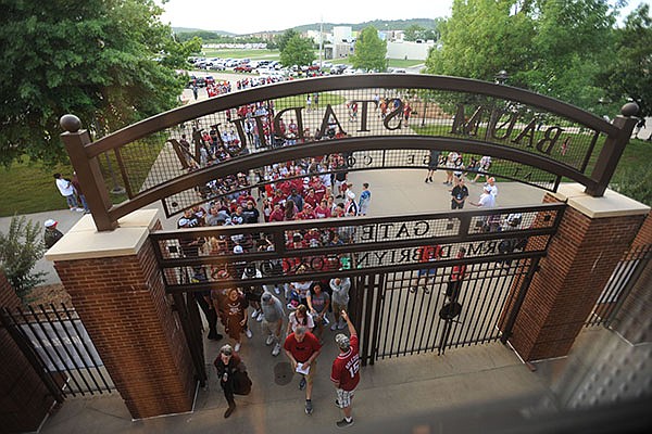 Arkansas and Missouri State fans enter the stadium Saturday, June 3, 2017,for the second round of the NCAA Baseball Regional at Baum Stadium in Fayetteville.