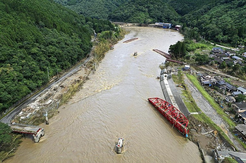 A drone image taken Wednesday in Kumamoto prefecture in southern Japan shows a bridge over the Kuma River that was swept away by flooding in Kuma village. More photos at arkansasonline.com/79japan.
(AP/Kyodo News/Koji Harada)