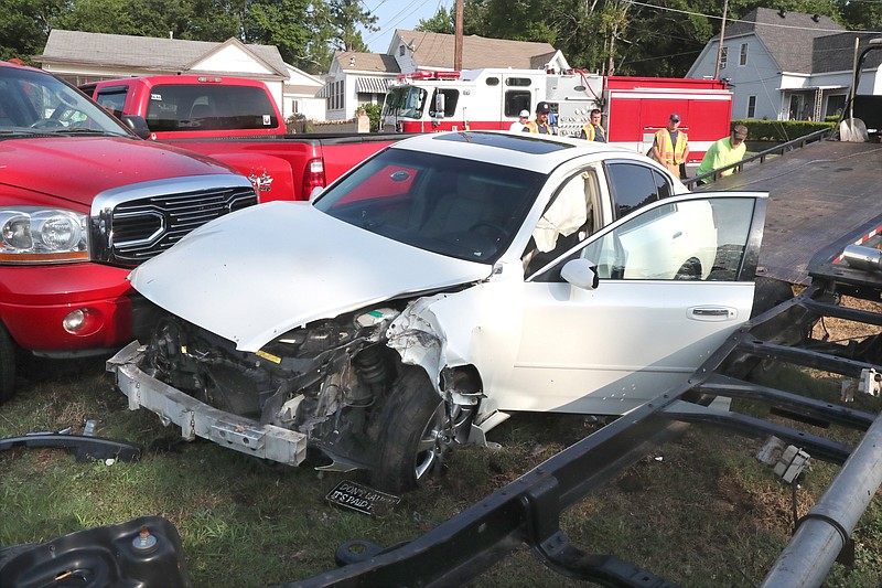 A 2005 Infiniti G35 damaged a utility pole and several other vehicles in the 400 block of Summer Street around 8 a.m. Friday, according to Hot Springs police. - Photo by Richard Rasmussen on The Sentinel-Record.