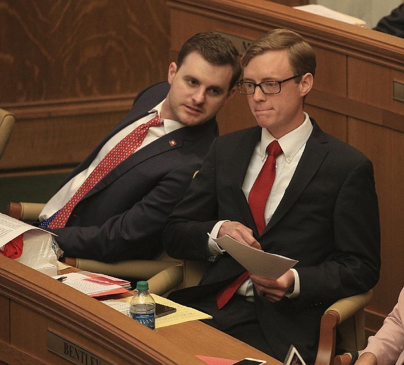 FILE — Rep. Austin McCollum (left) confers Friday with Rep. Grant Hodges in this March 29, 2019 file photo. 