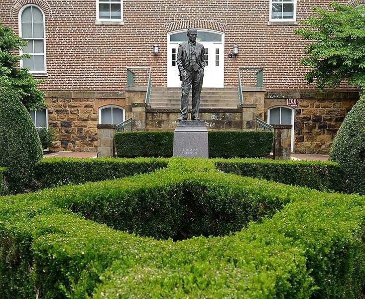 A statue of J. William Fulbright stands Wednesday, July 1, 2020, near the west entrance of Old Main on the University of Arkansas campus in Fayetteville. The statue was dedicated in 2002. (NWA Democrat-Gazette/Andy Shupe)