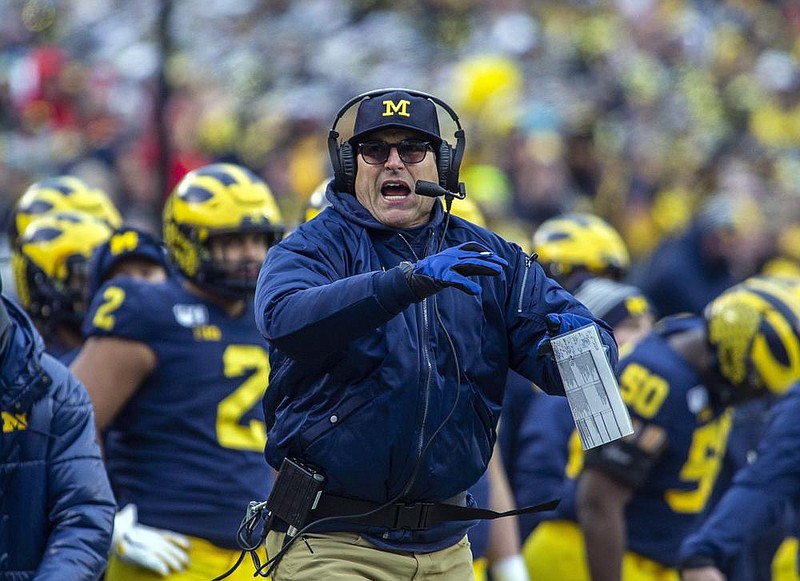 Michigan Coach Jim Harbaugh and the Wolverines will join the rest of the Big Ten in not playing nonconference games in football and several other sports this fall in a decision the league announced Thursday.
(AP file photo)