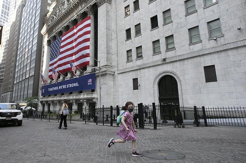 A girl runs near the New York Stock Exchange on Thursday. Worry that the economy may be losing steam sent stocks lower in Thursday trading.
(AP/Mark Lennihan)