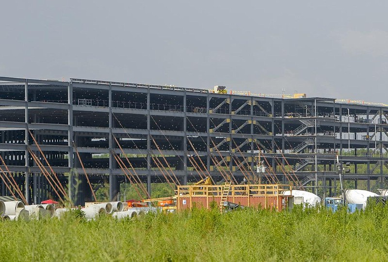 Construction continues Thursday on an Amazon facility of Zeuber Road, near the Port of Little Rock. The five-story warehouse will be four times larger than Amazon officials indicated earlier this week.
(Arkansas Democrat-Gazette/John Sykes Jr.)