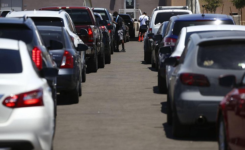 Motorists wait in lines Thursday at a drive-thru coronavirus testing site at South Mountain Community College in Phoenix.
(AP/Ross D. Franklin)